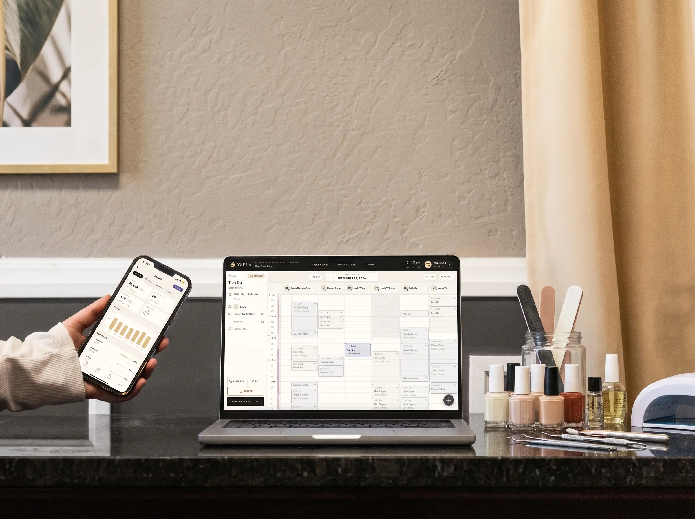 A salon’s Ovela booking page on a laptop and a phone, beside a row of polish